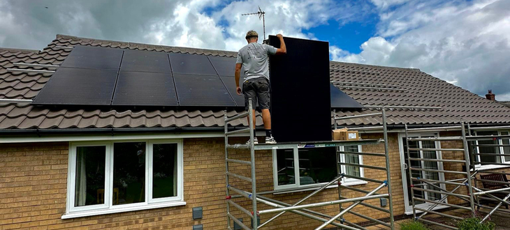 Image of a roofer fitting in a solar panel 